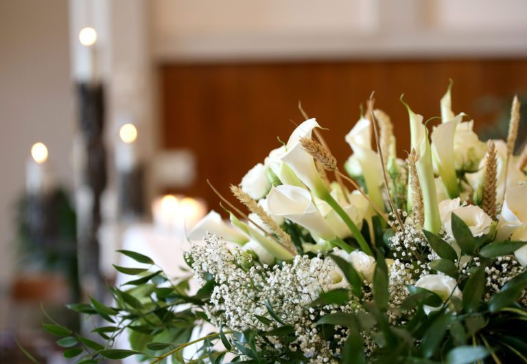 A simple wreath of white lilies and cream roses